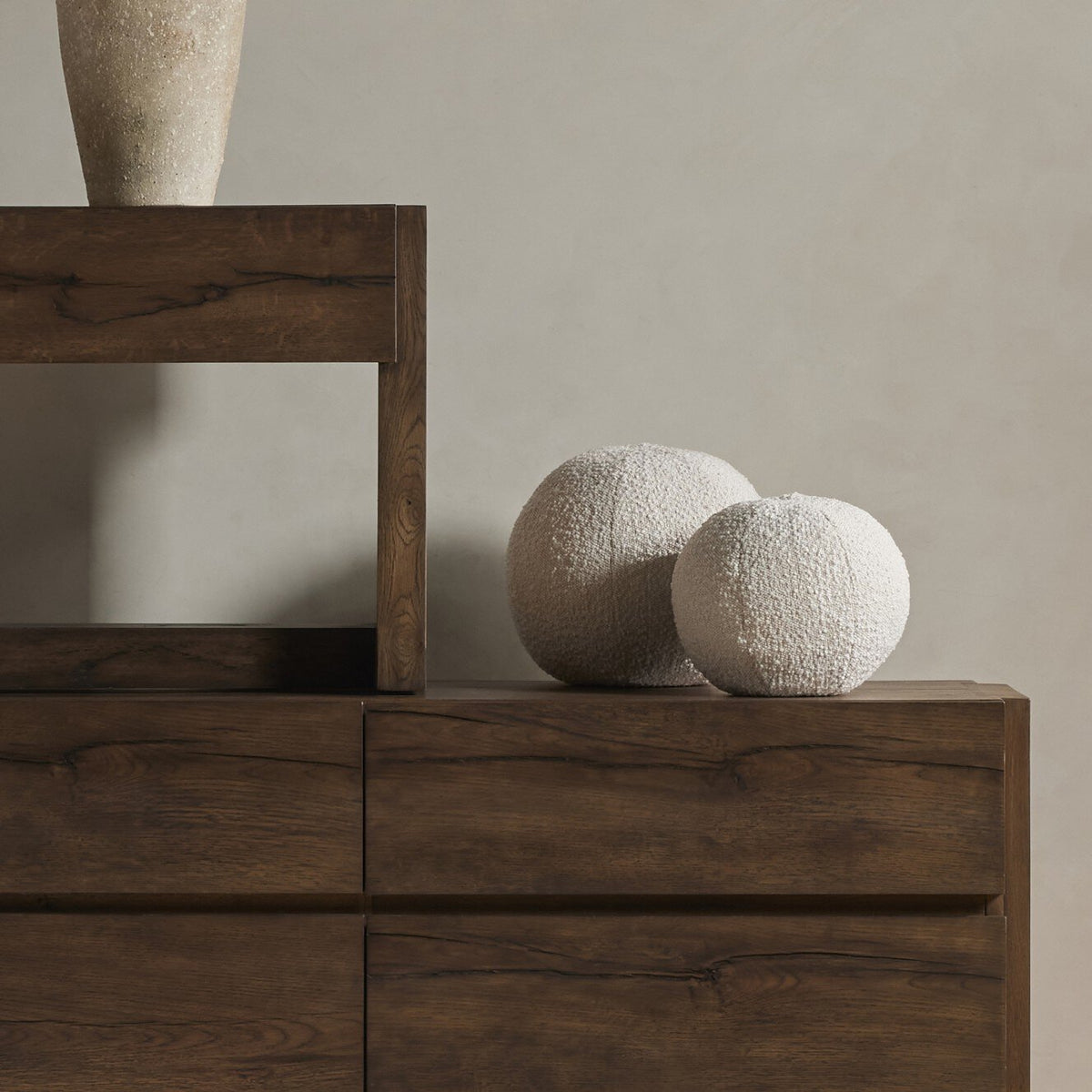 a wooden dresser with a vase on top of it