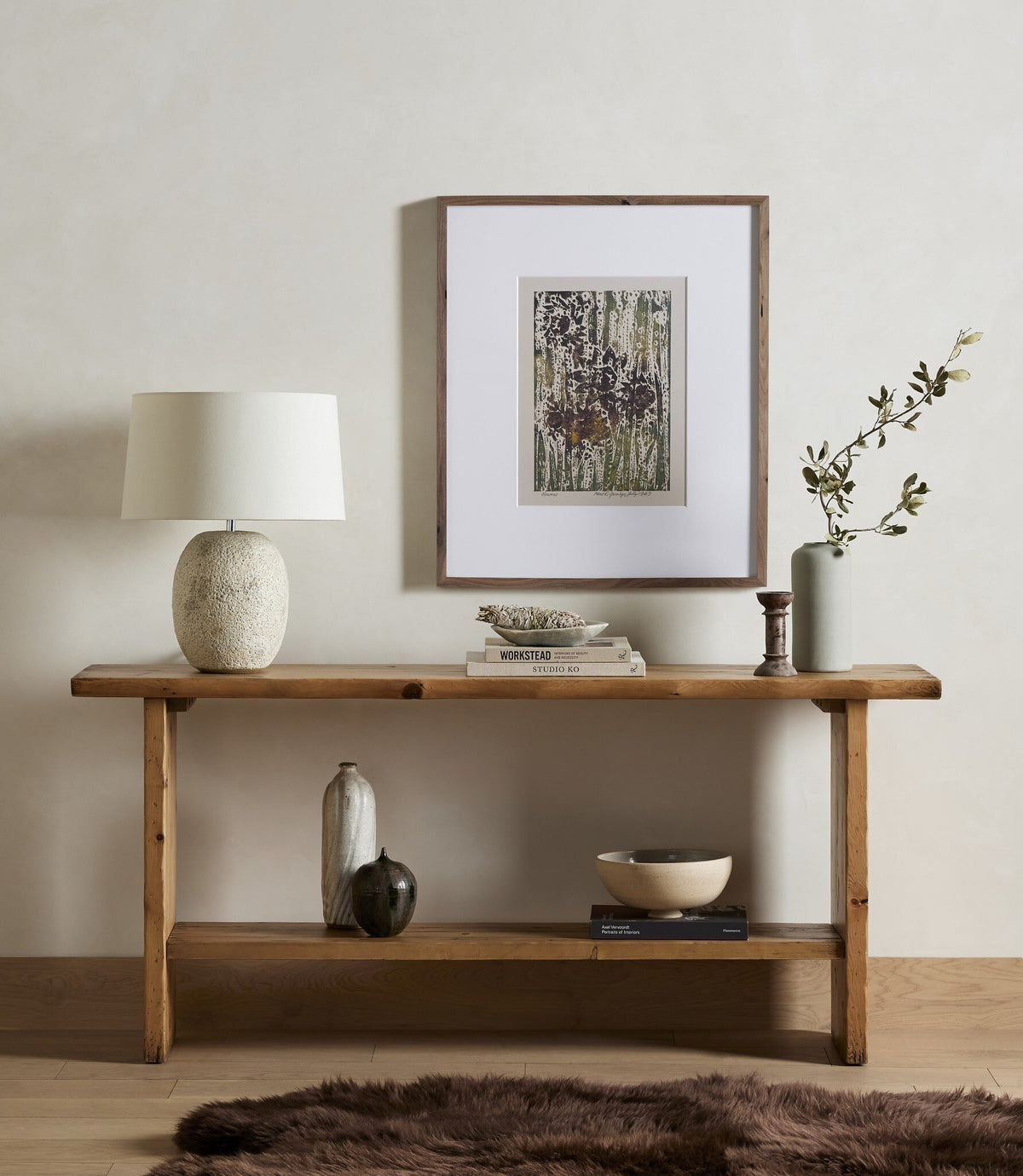 a table with a lamp and vases on it