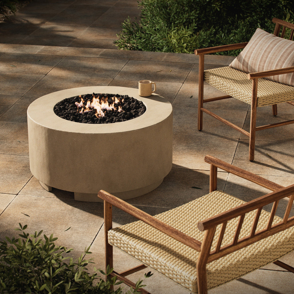 a fire pit and chairs on a patio