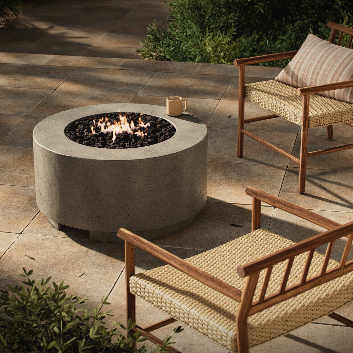 a fire pit and chairs on a patio