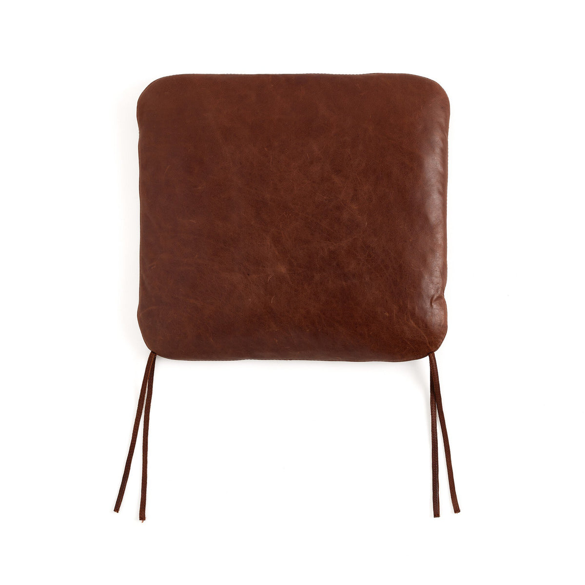 a brown square pillow with string