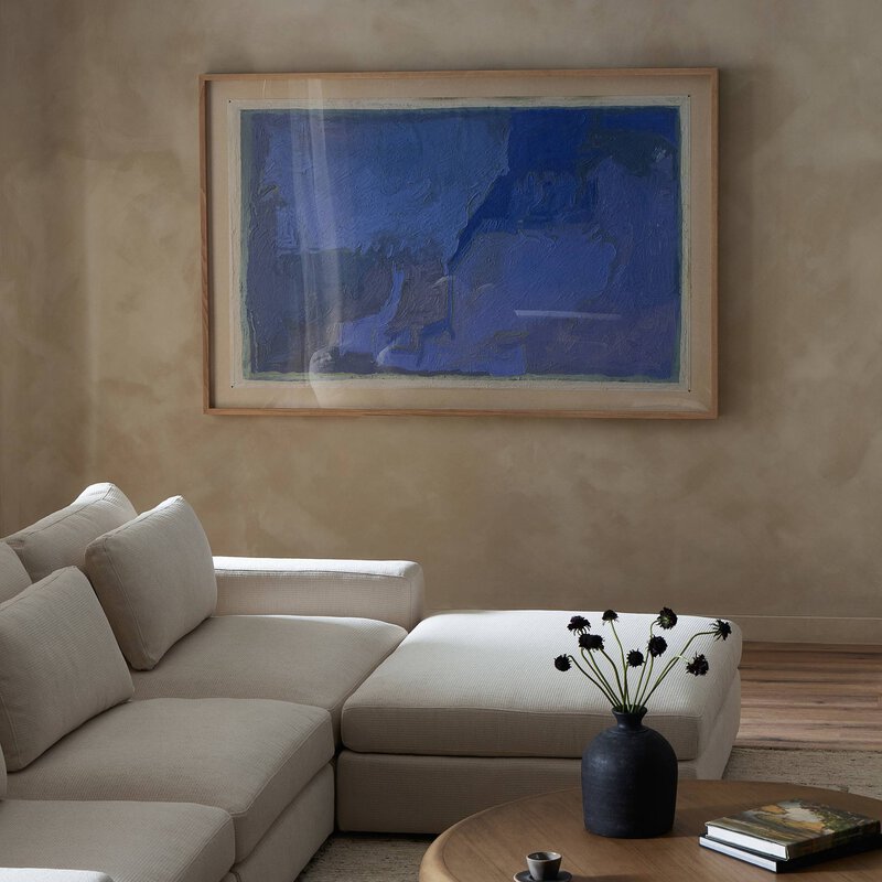 a living room with a large painting on the wall