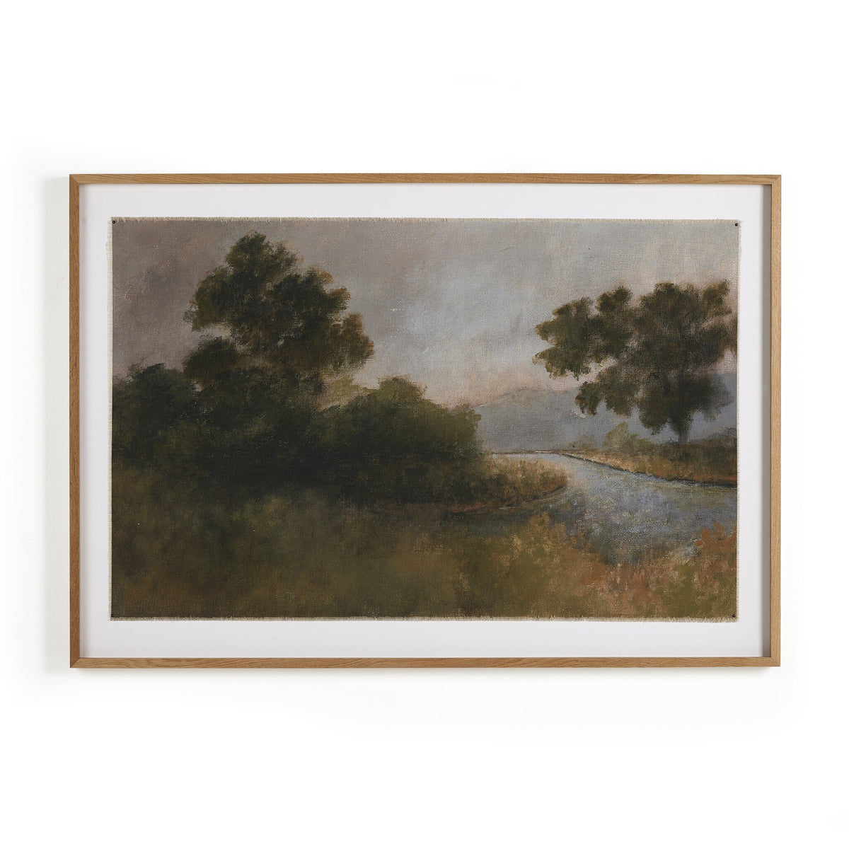 a framed picture of trees and a river