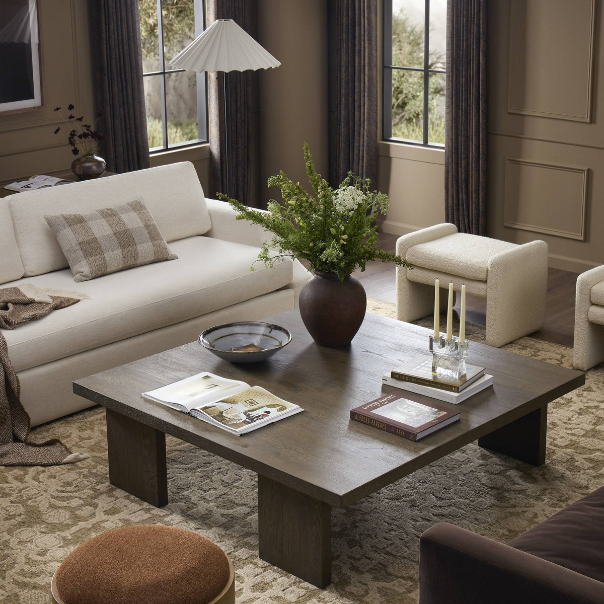 a living room with a coffee table and couches