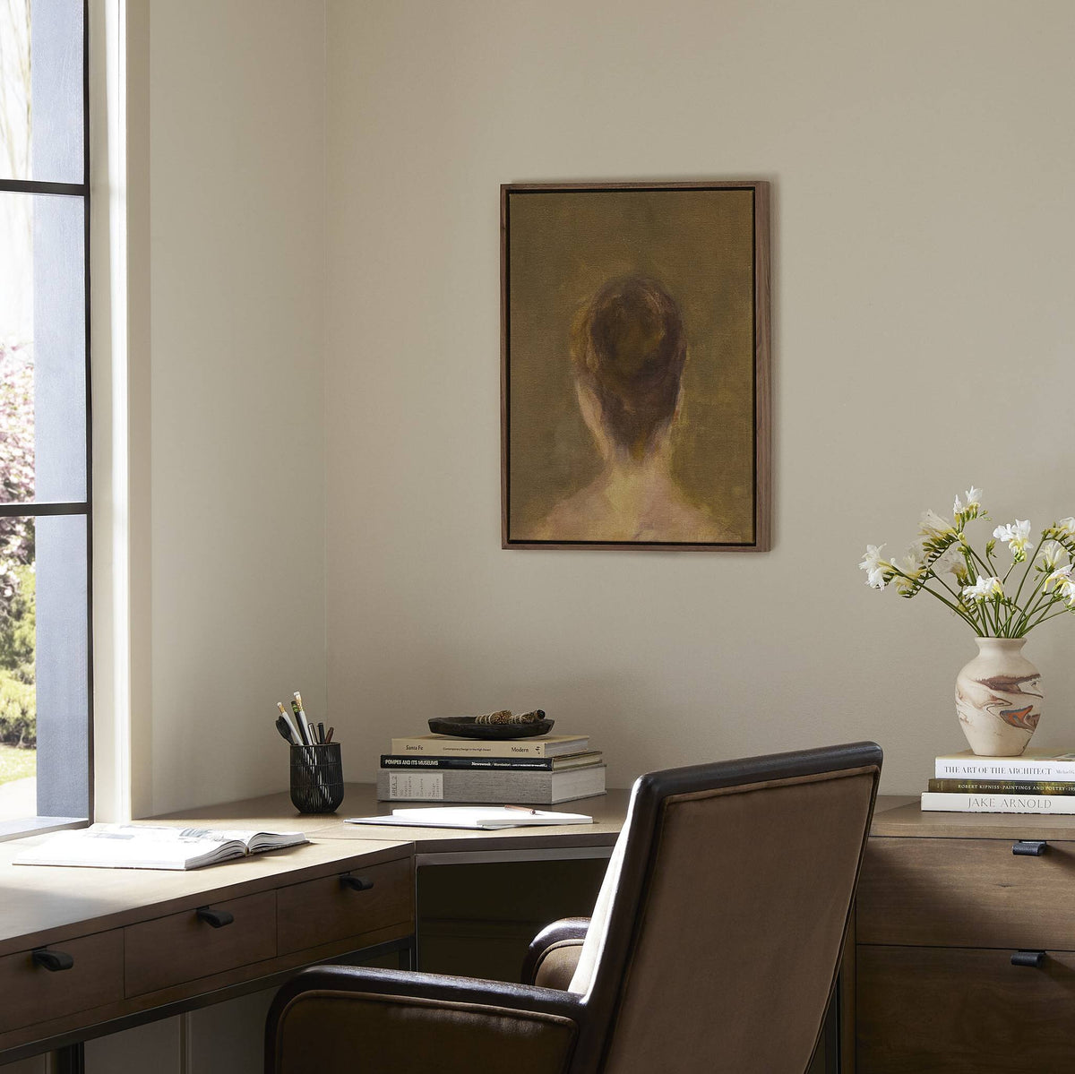 a desk with a painting on the wall