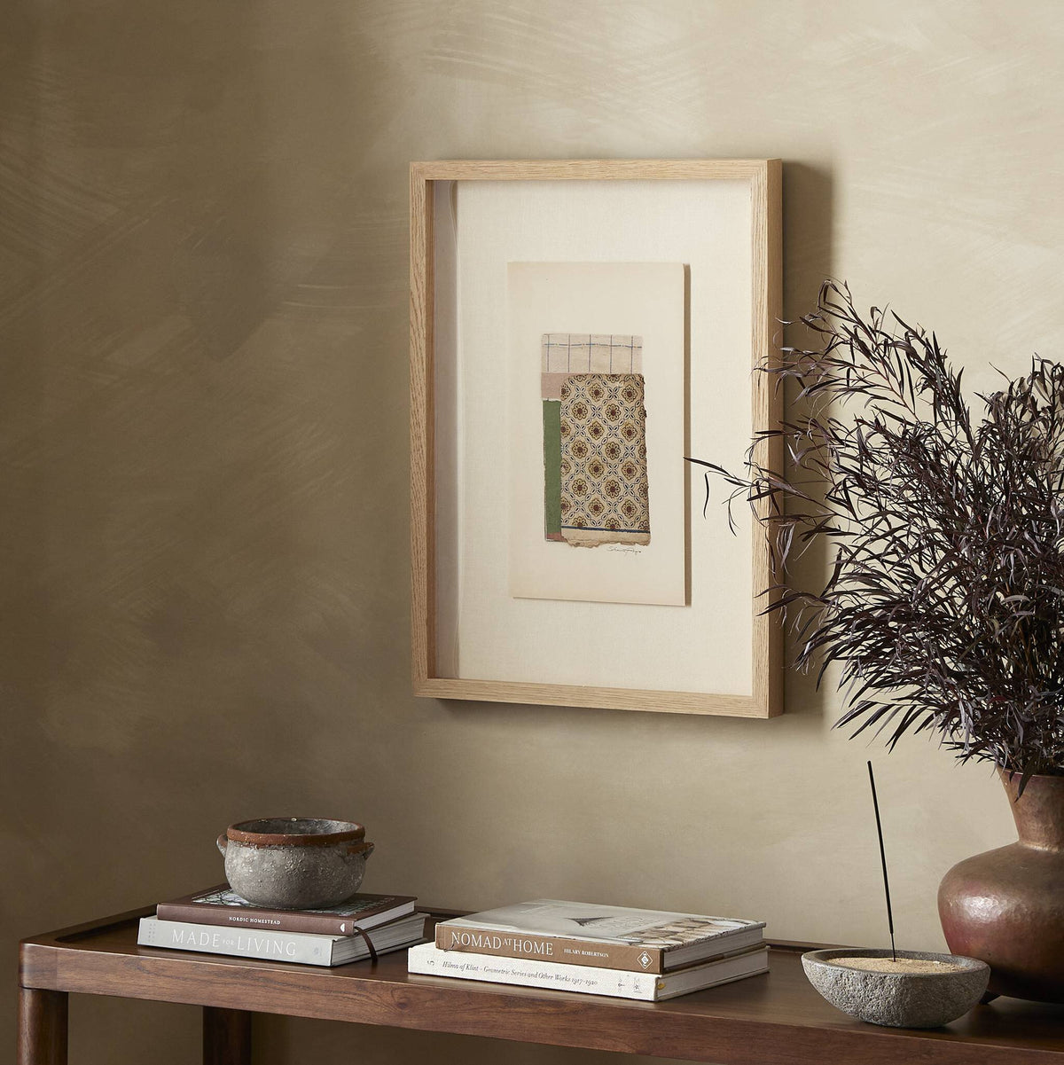 a table with a picture frame and books on it