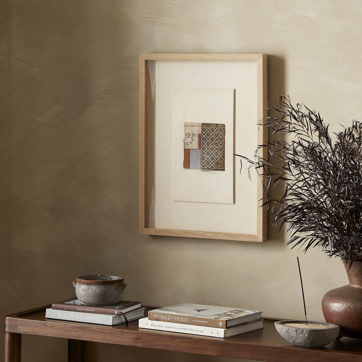 a table with a picture frame and a plant on it