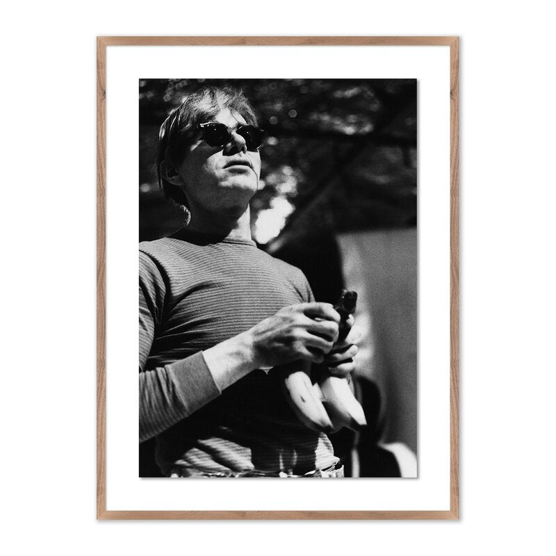 a man holding bananas in a frame