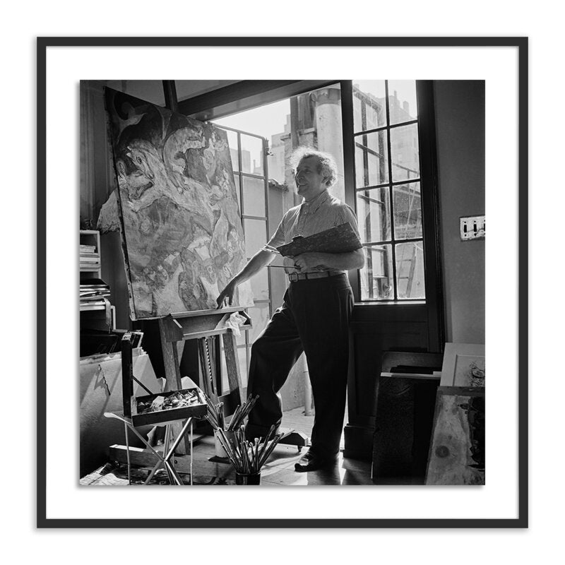 a man standing in front of a painting