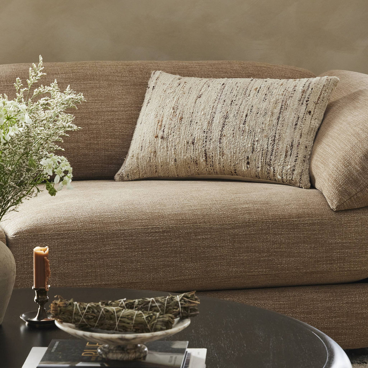 a couch with a vase of flowers