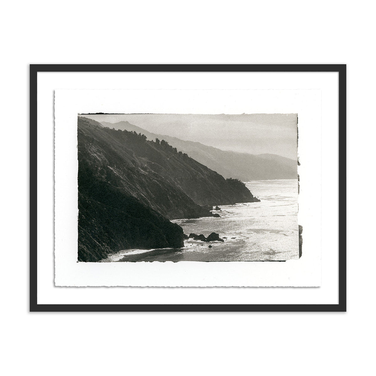 a framed picture of a cliff