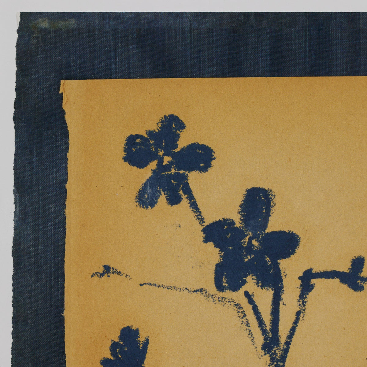a blue flower on a yellow surface