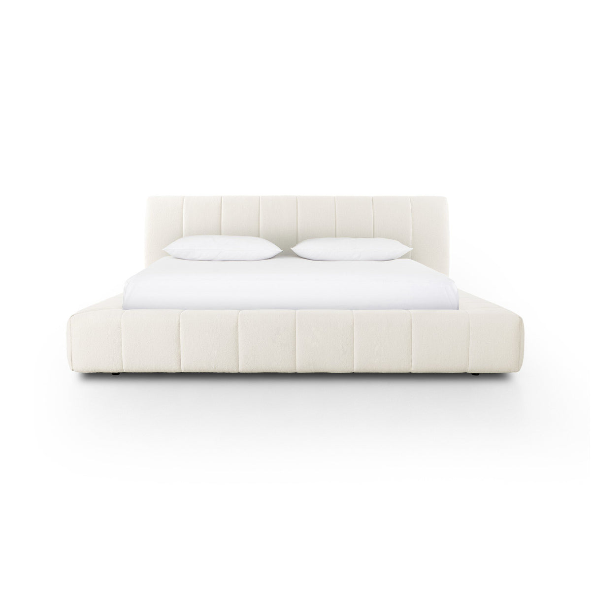a white bed with pillows