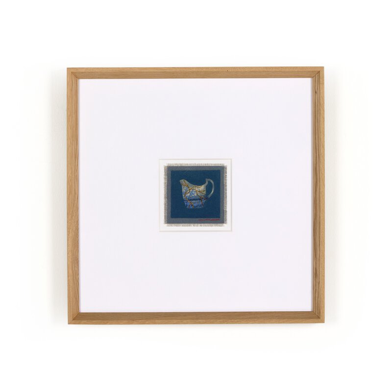 a framed picture of a blue square with a blue and gold design