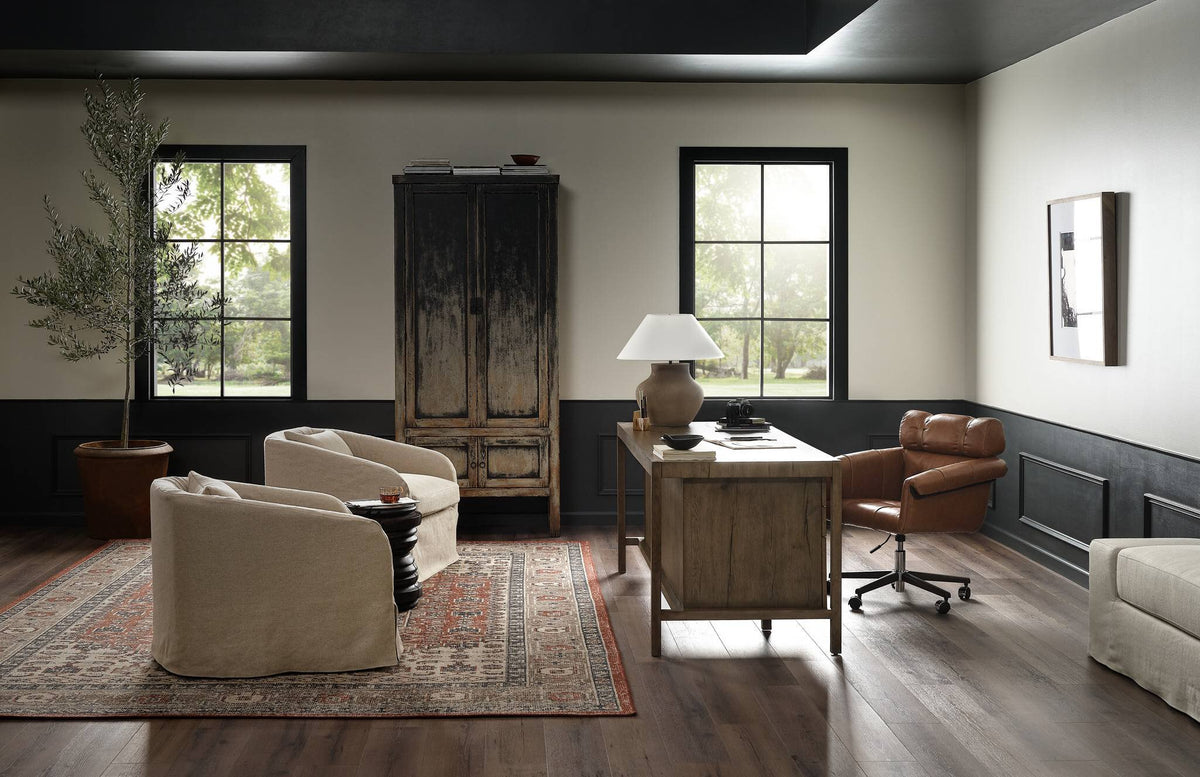 a room with a desk and chairs