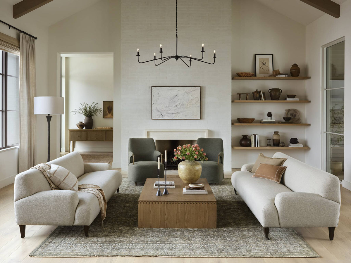 a living room with a fireplace and couches