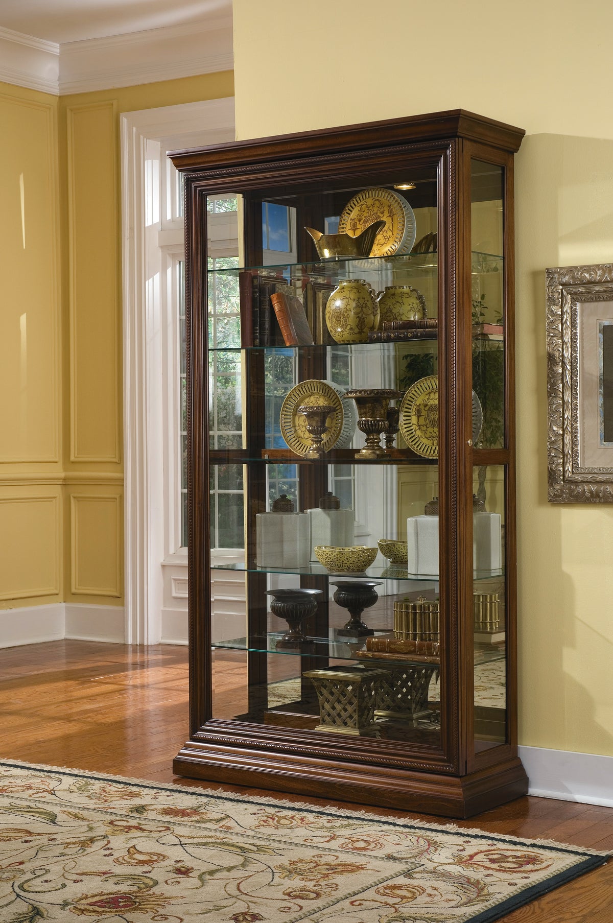 a glass cabinet with various objects on it