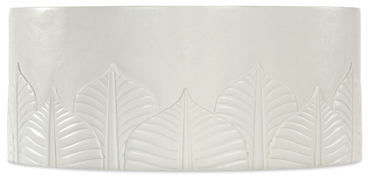 a white rectangular object with leaves carved on it