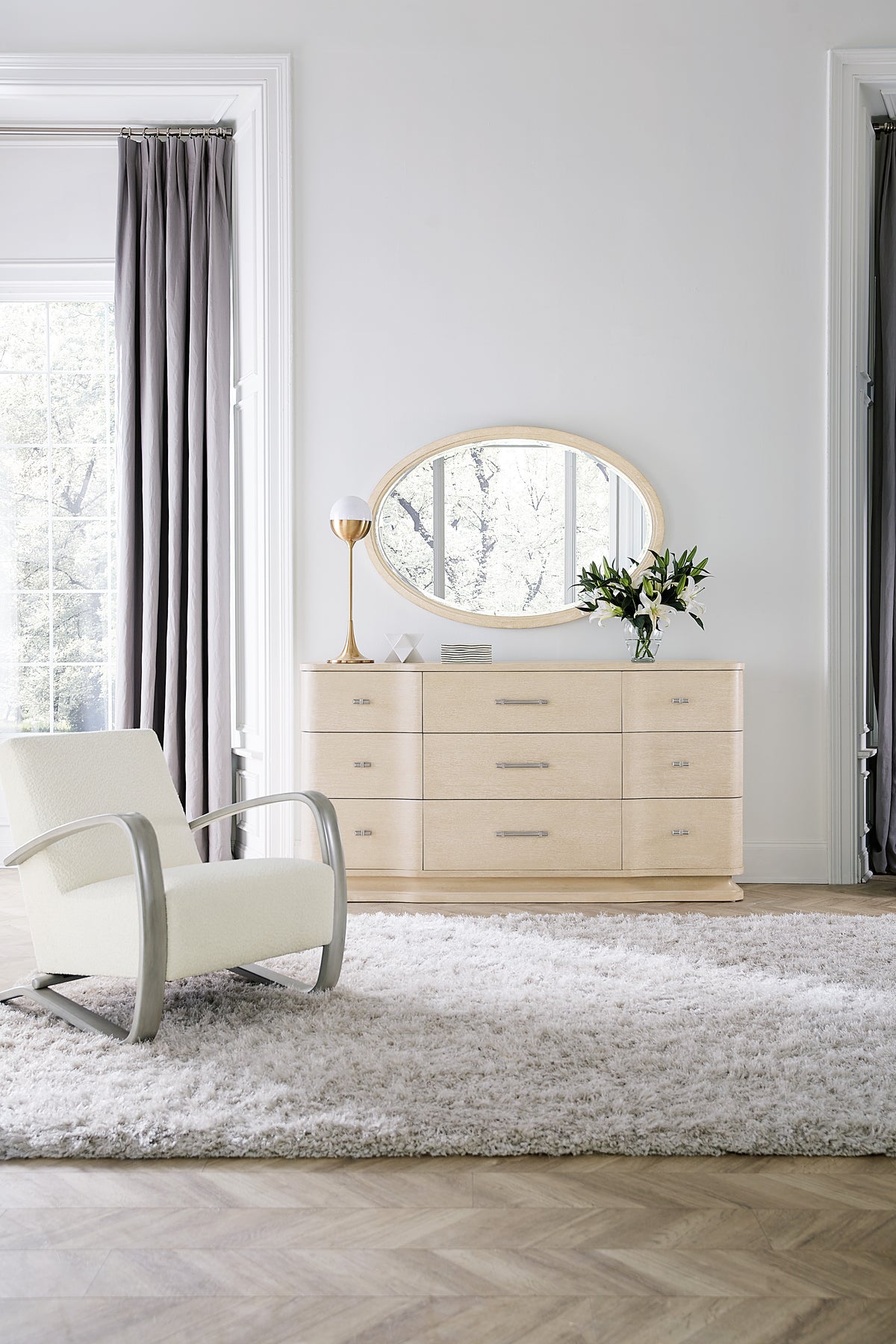 a white chair next to a dresser
