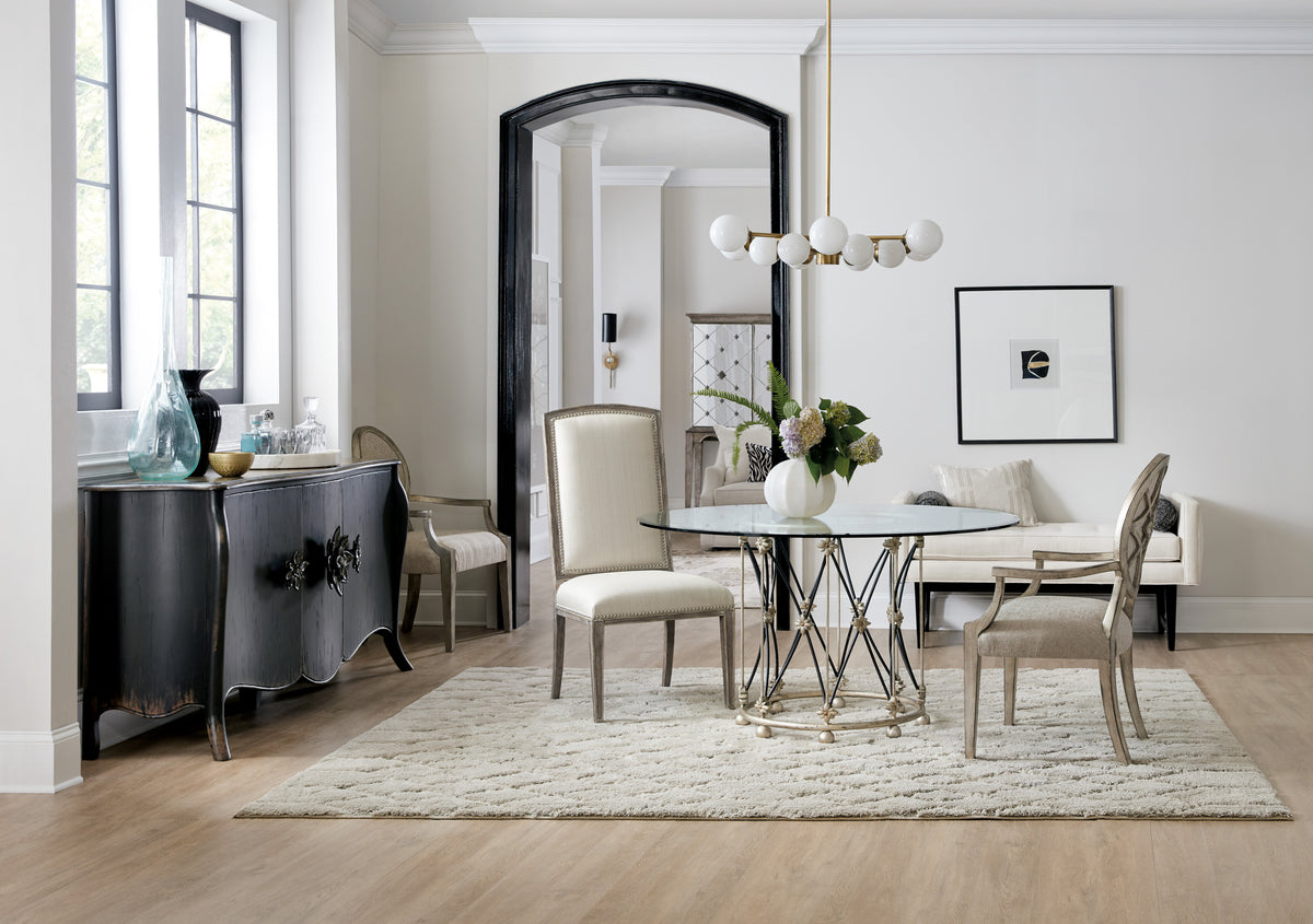 a dining room with a glass table and chairs