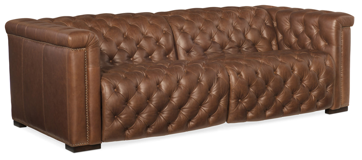 a brown leather couch with buttons