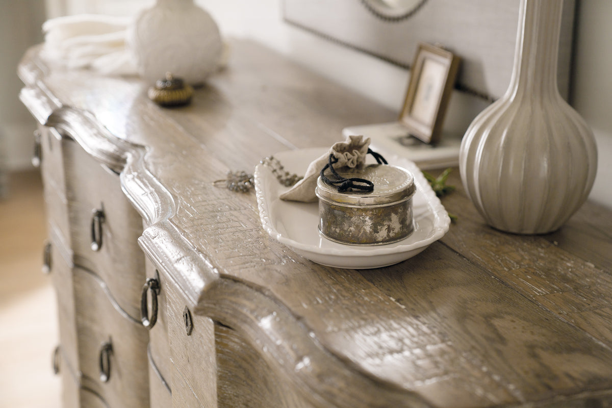 a white plate with a silver object on it on a wooden surface