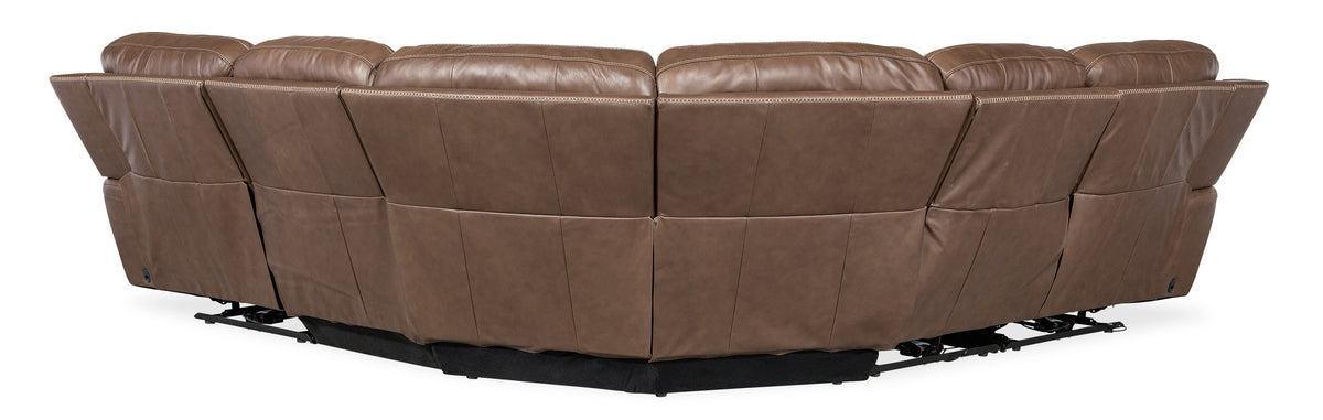 a brown leather couch with black base