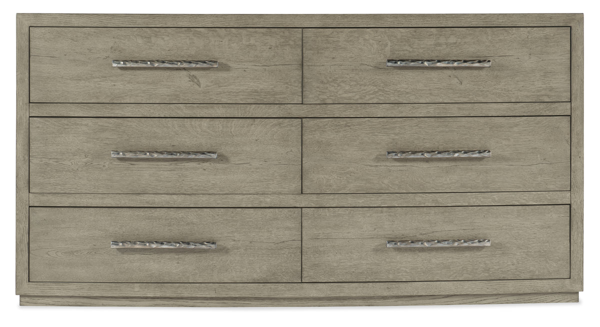 a wooden dresser with metal handles