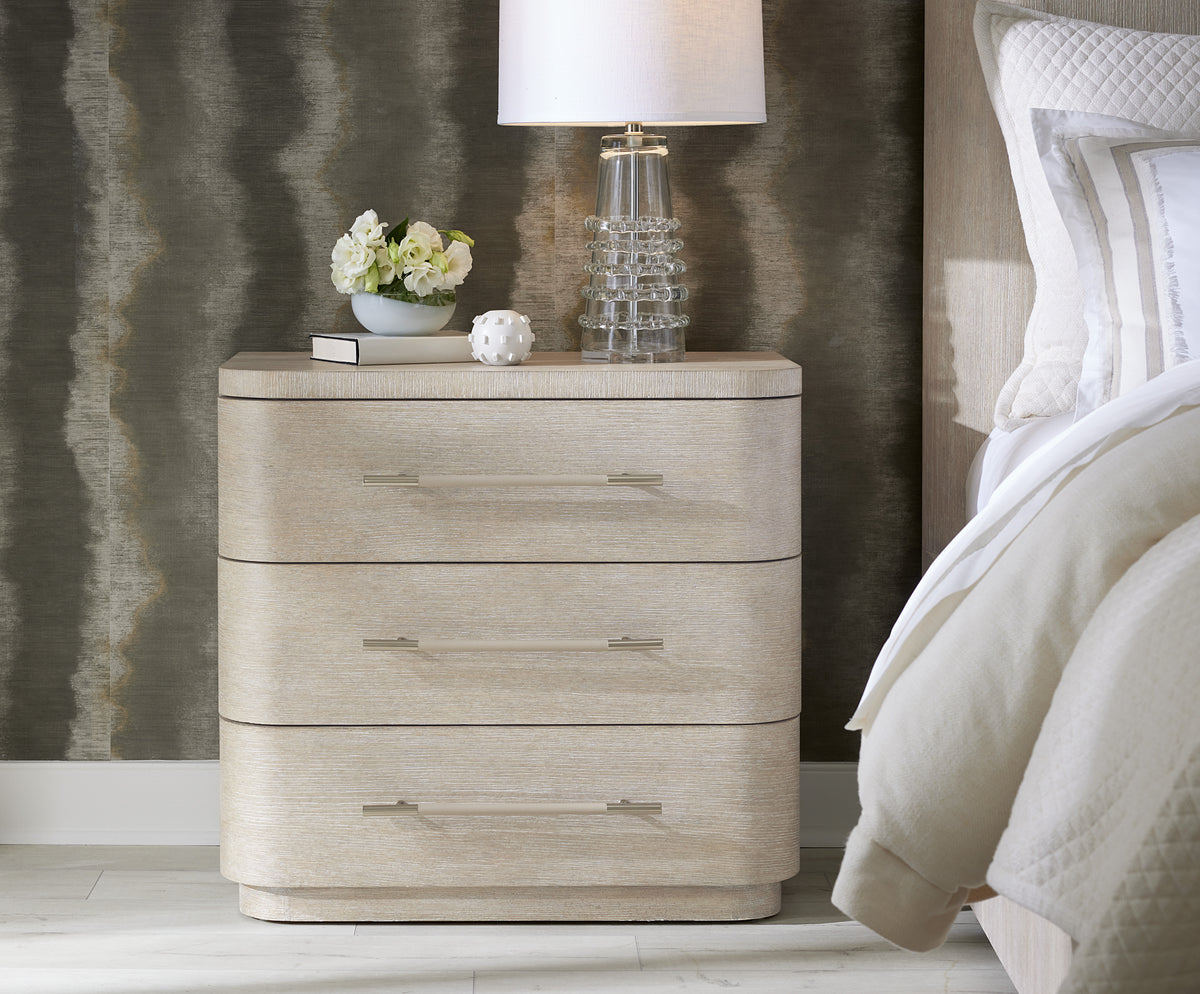 a nightstand with a lamp on top