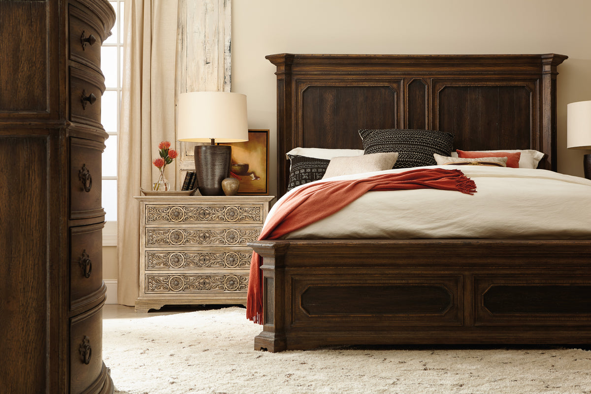 a bed with a lamp and a dresser