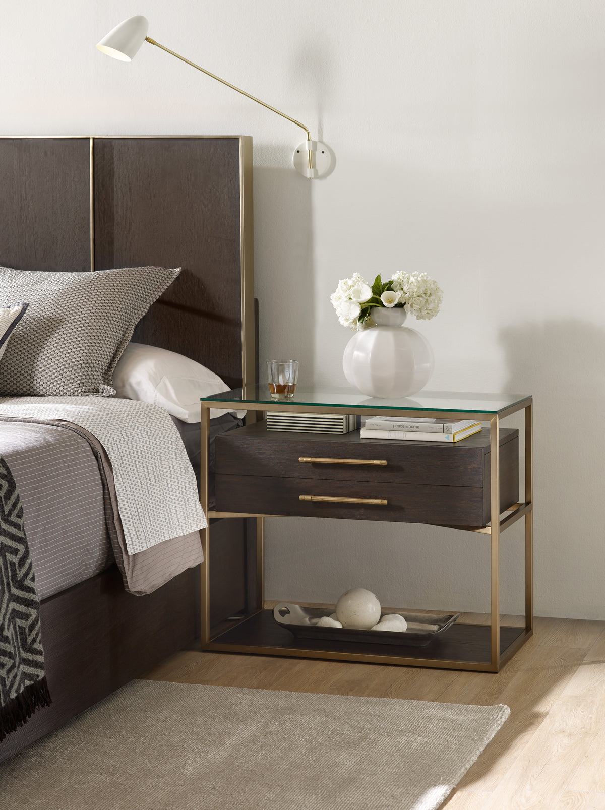 a nightstand next to a bed