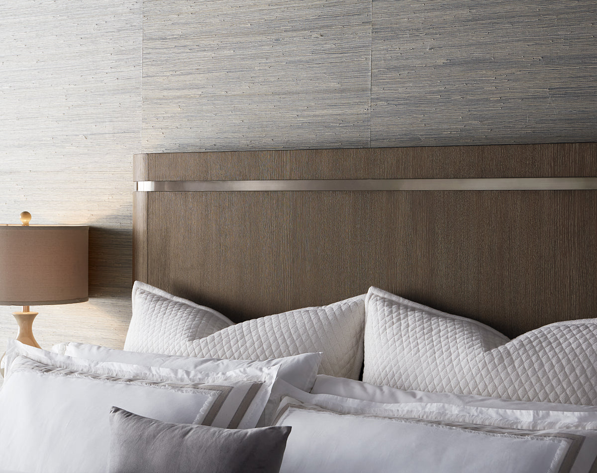 a bed with pillows and a lamp