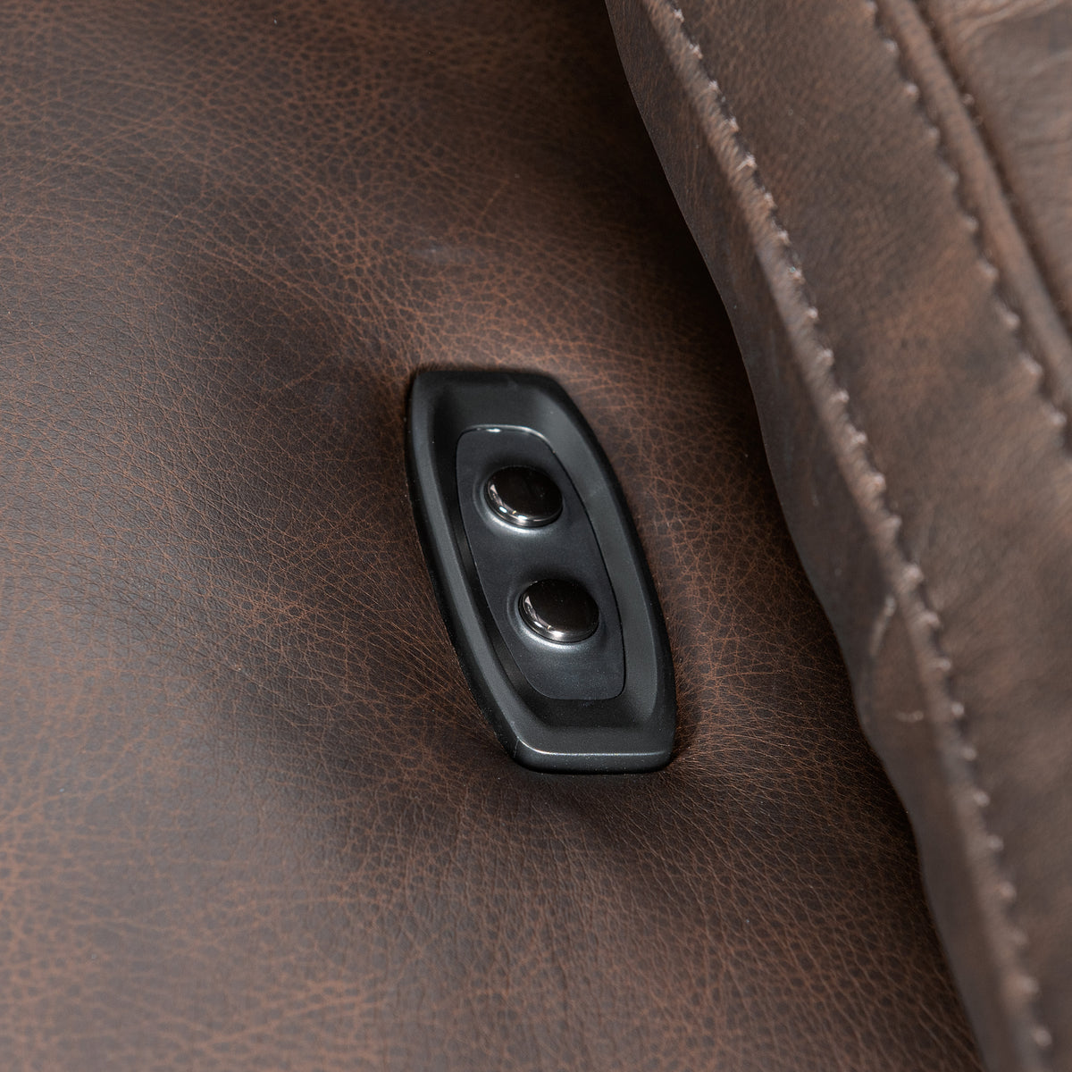 a close up of a button on a leather couch