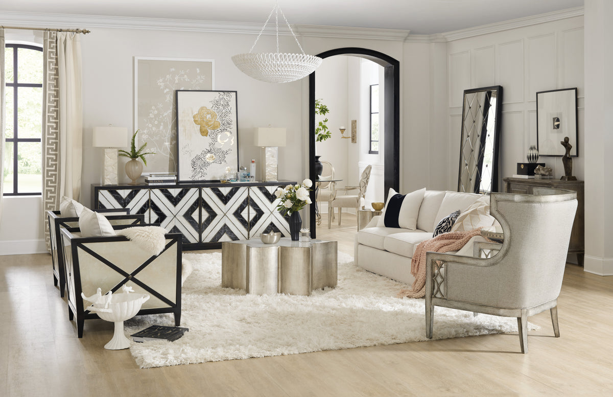 a living room with a white couch and a black and white rug