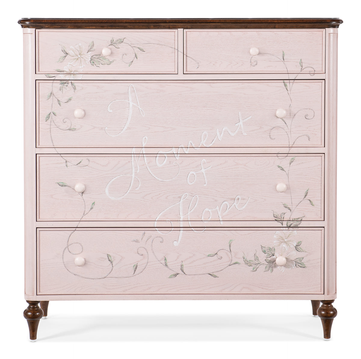 a pink dresser with white writing on it