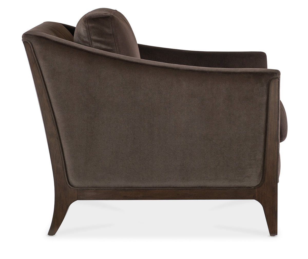 a brown chair with a pillow