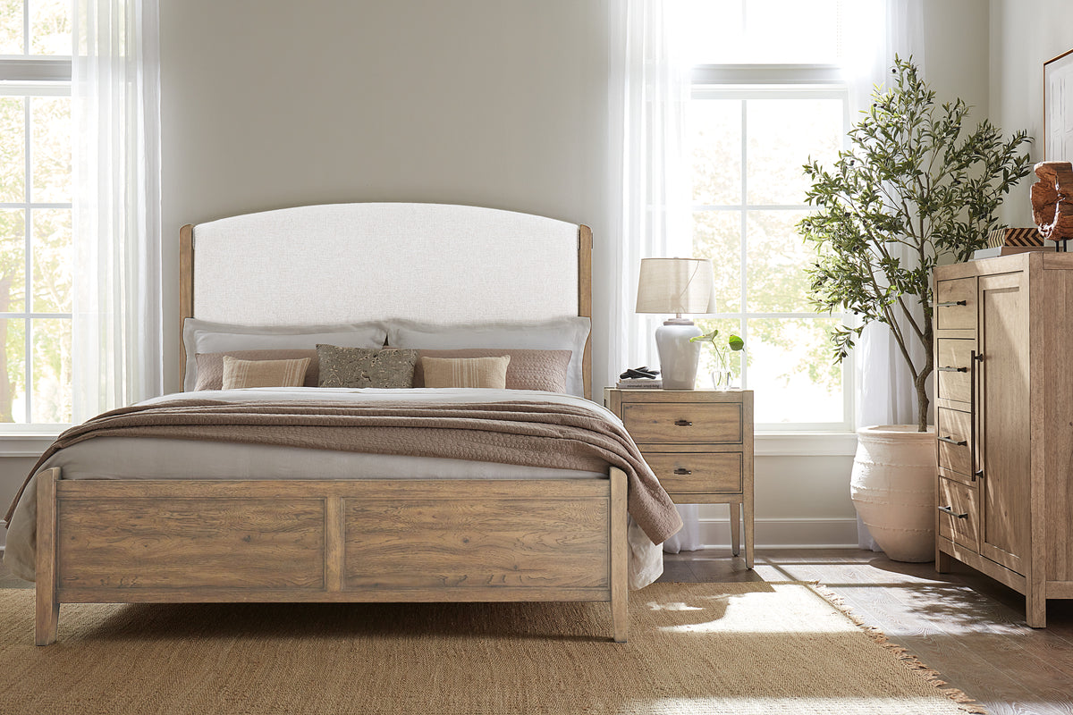 a bedroom with a bed and a plant