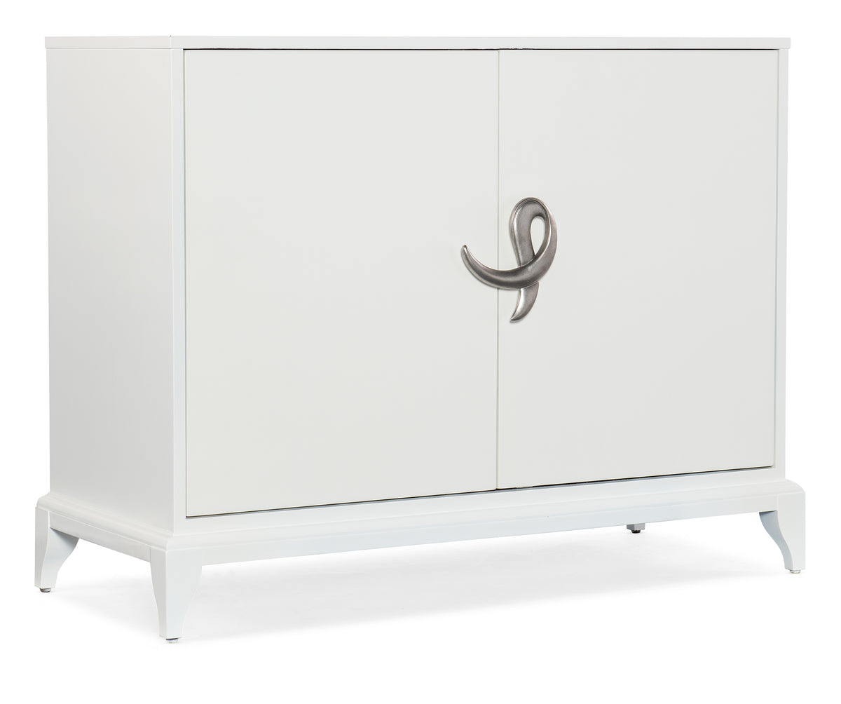 a white cabinet with a silver handle