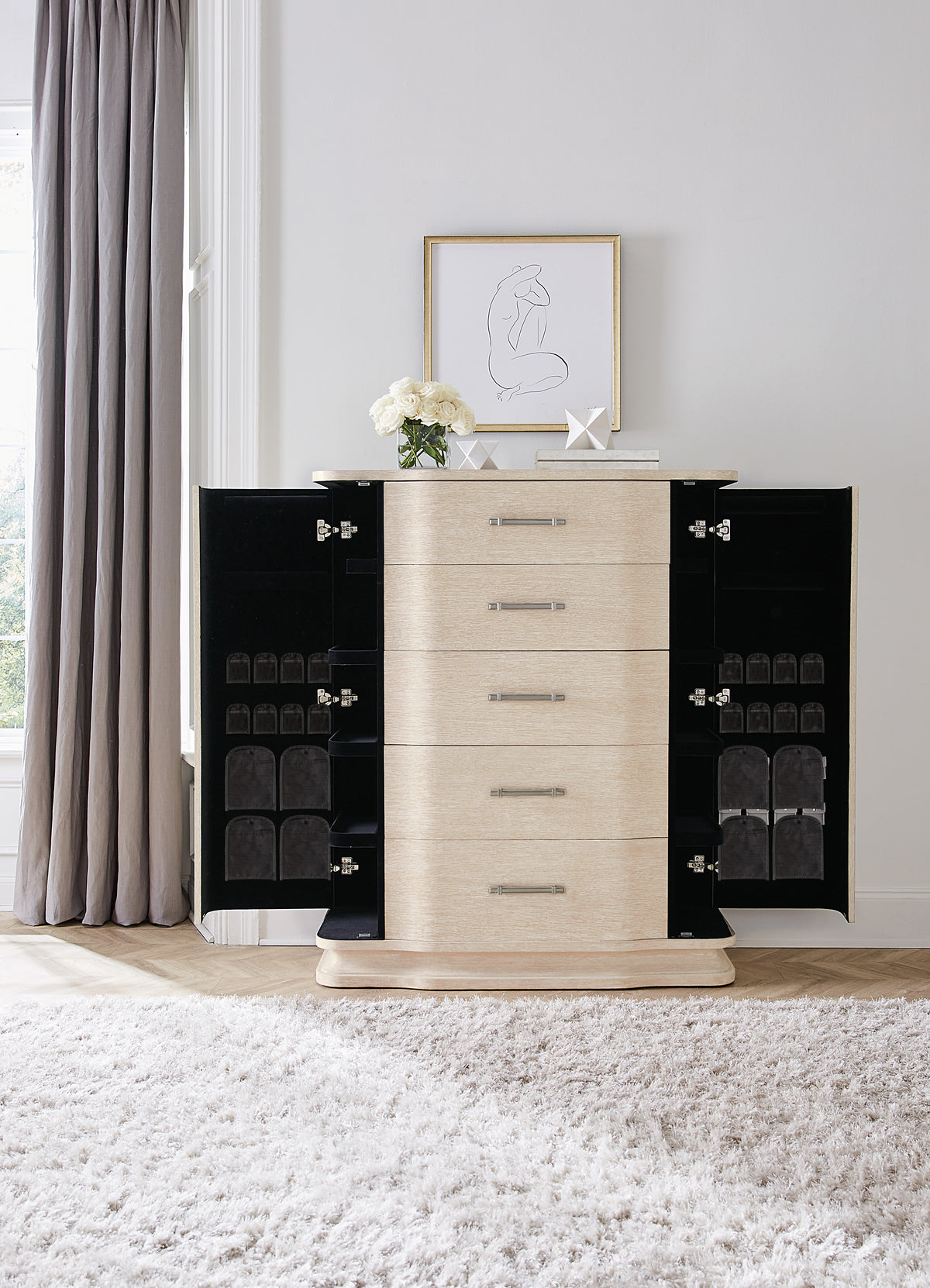 a dresser with a picture on the wall