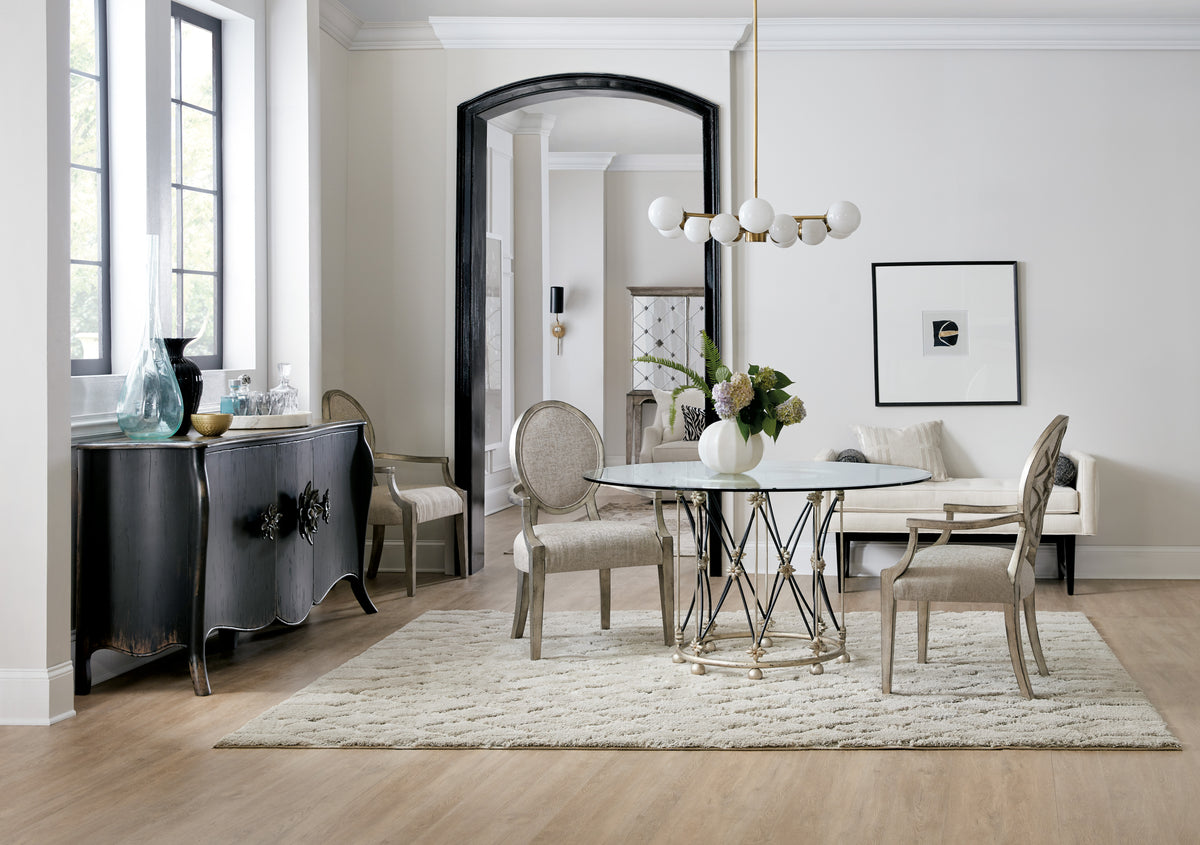 a dining room with a glass table and chairs