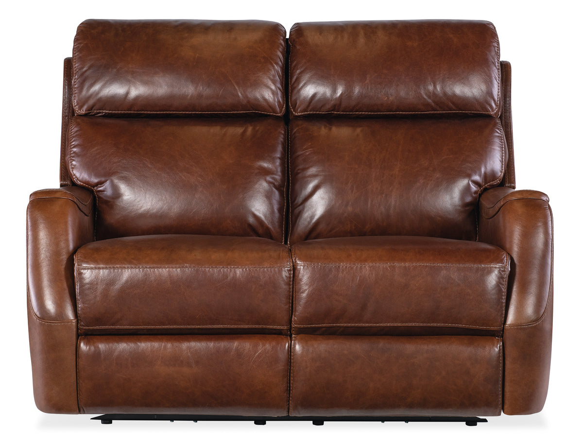 a brown leather couch with two recliners