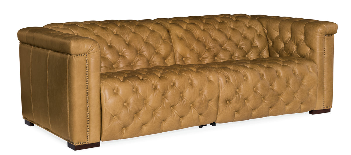a brown leather couch with buttons