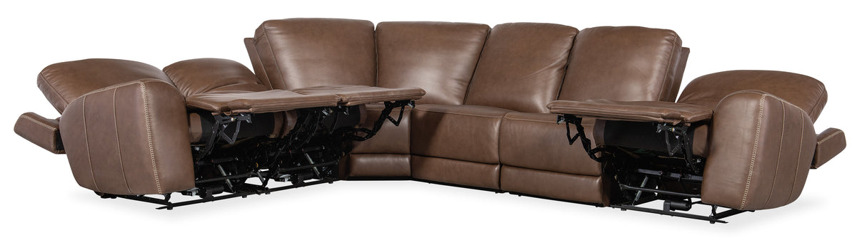 a brown leather couch with a table