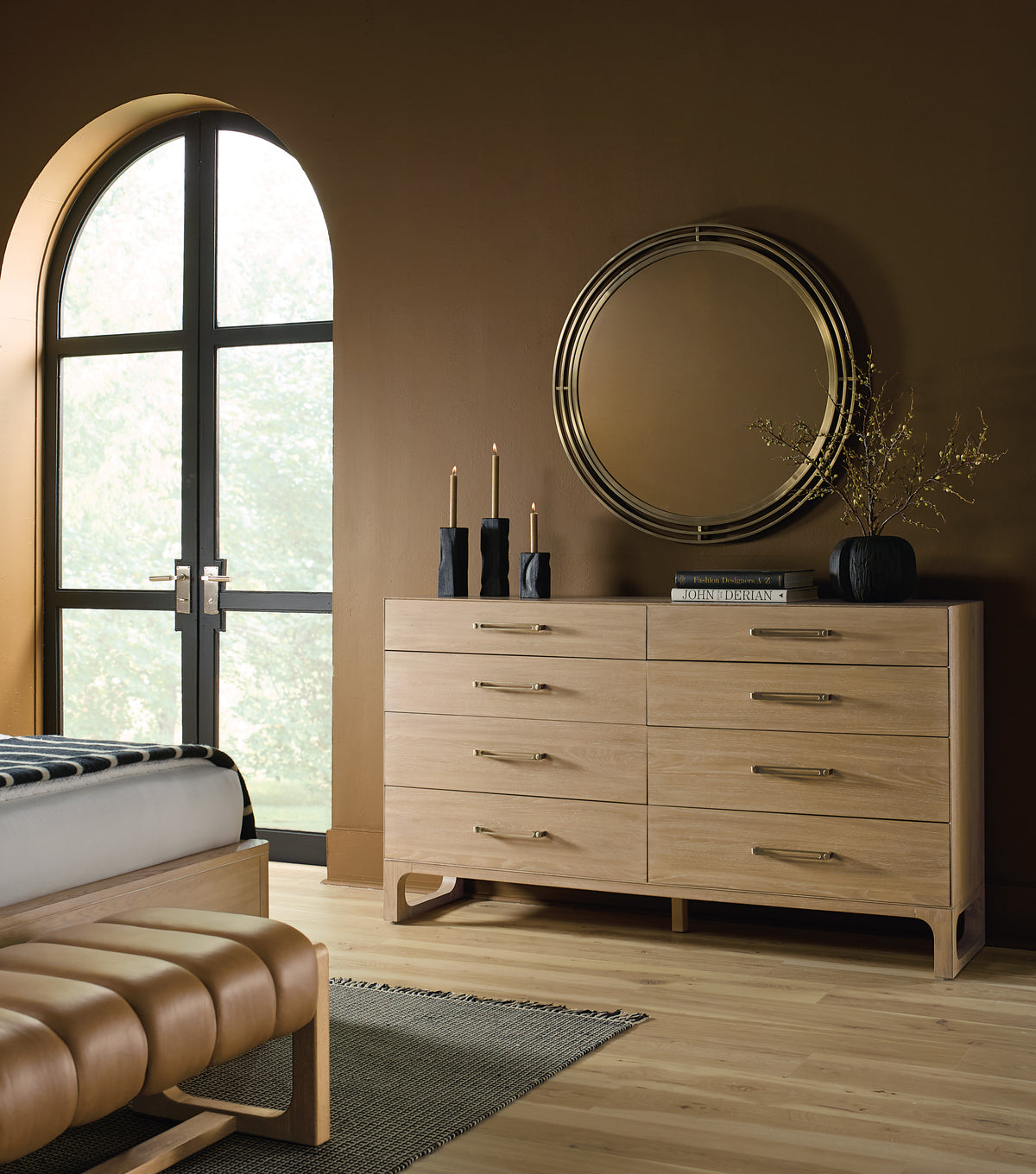 a bedroom with a dresser and mirror