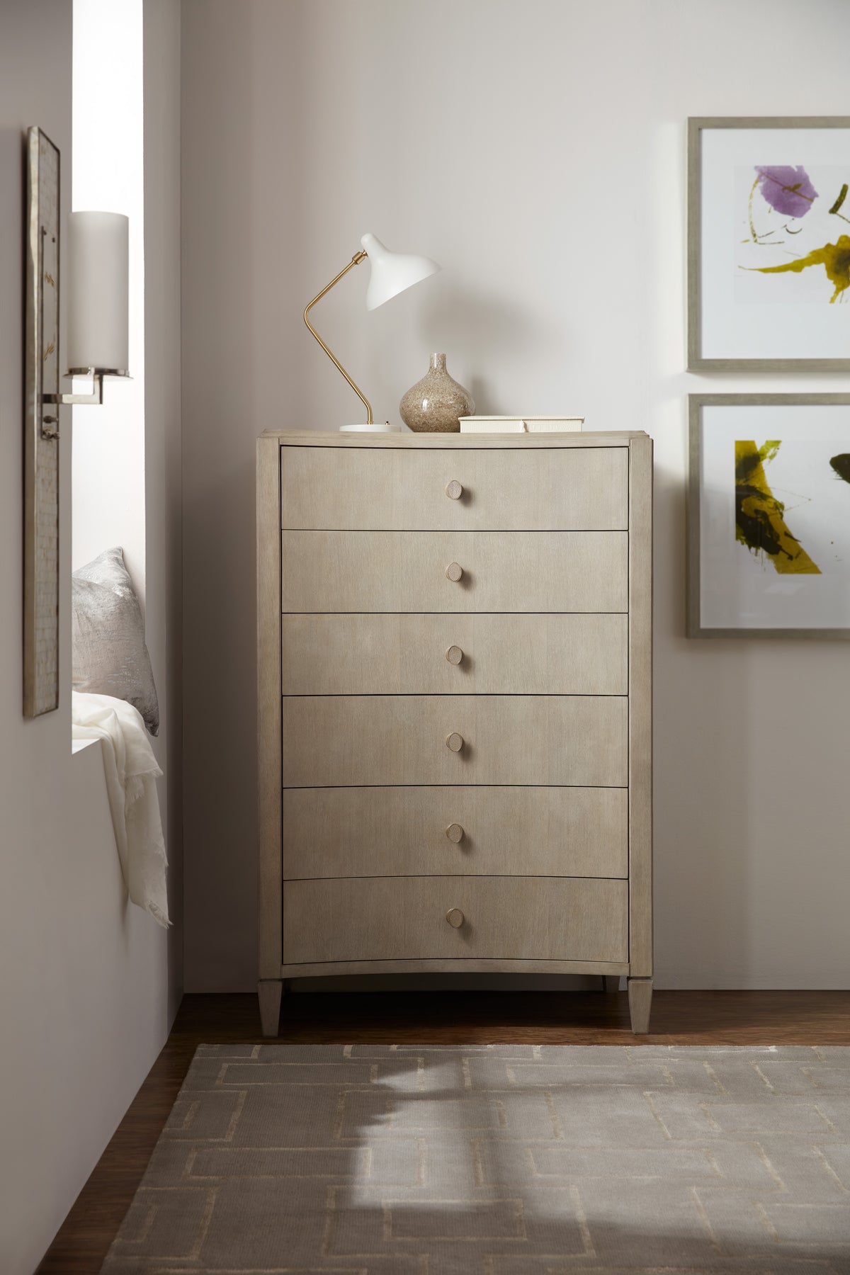 a dresser with a lamp on top