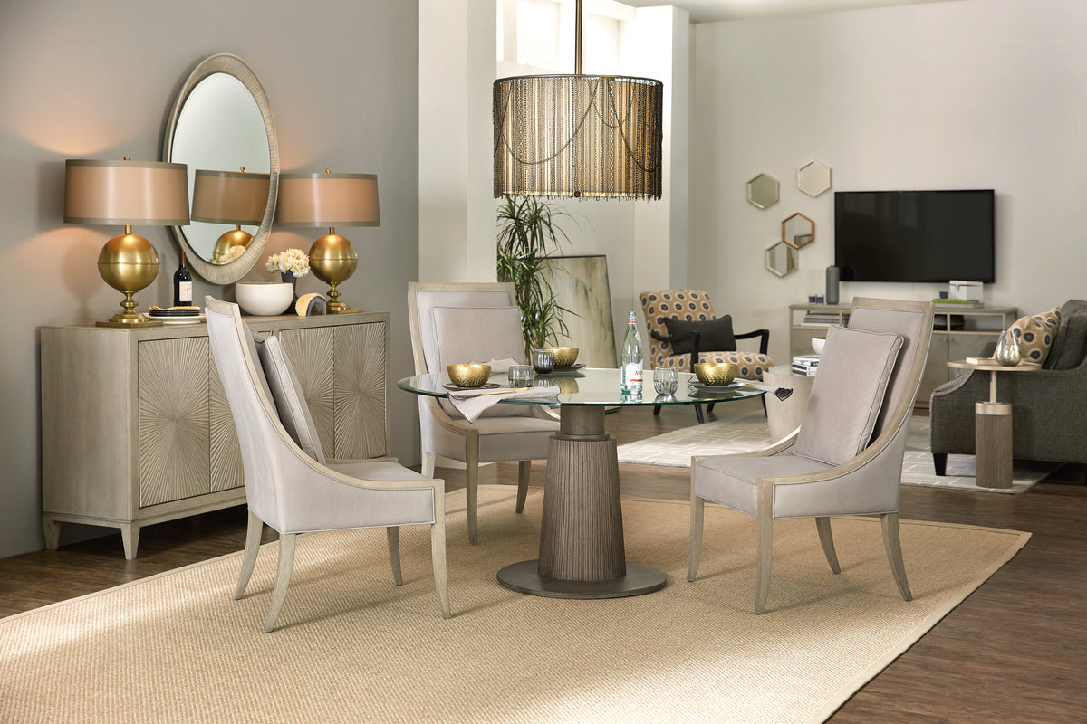 a living room with a glass table and chairs