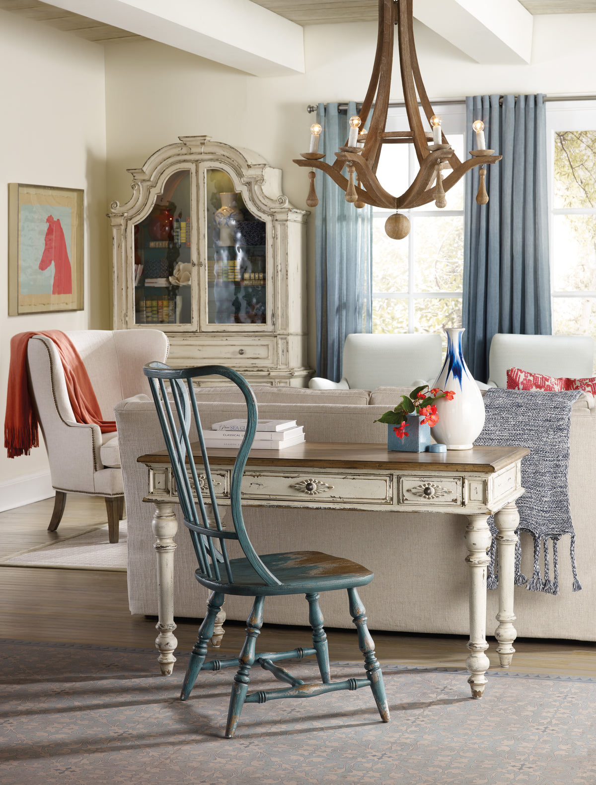 a living room with a desk and chair