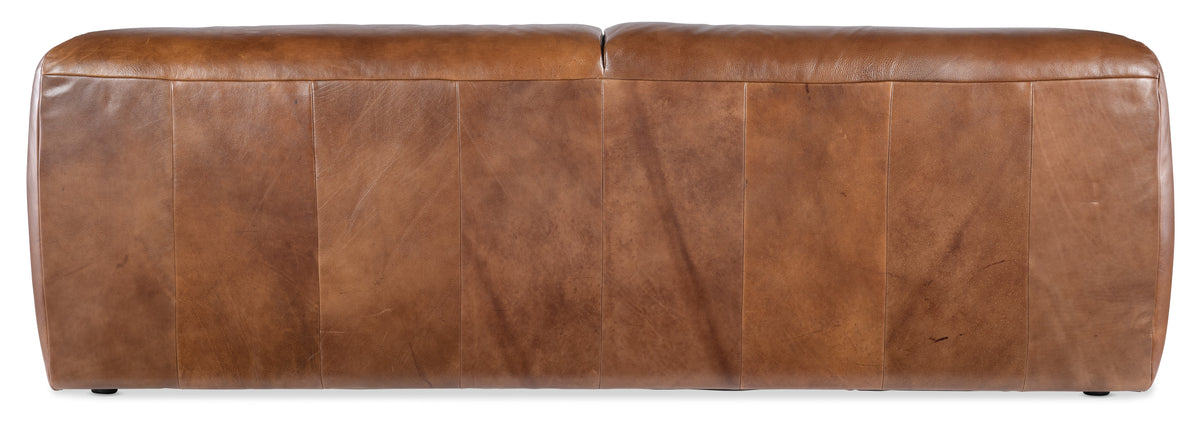 a brown leather couch with four rows of strips