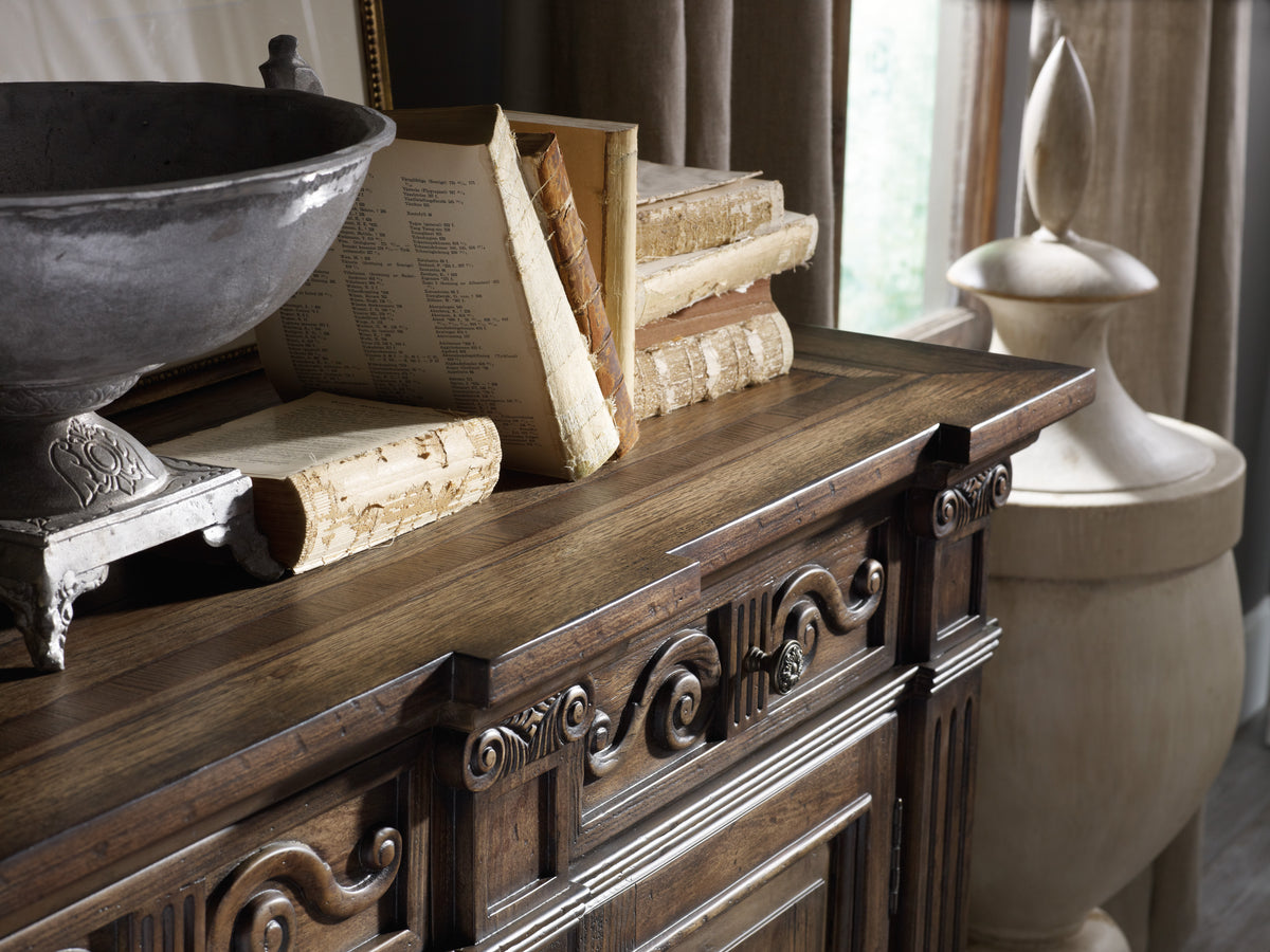 a wooden dresser with a bowl of books and a bowl of wood