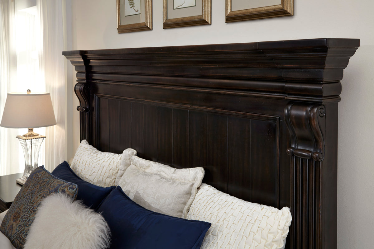 a bed with pillows and a white fluffy blanket